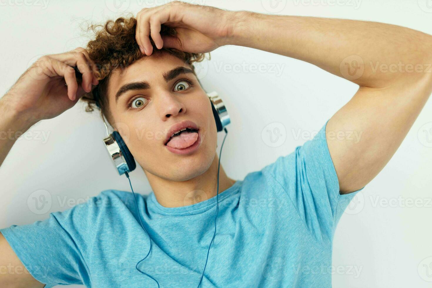 bonito jovem homem dentro azul Camisetas fones de ouvido moda estilo de vida inalterado foto