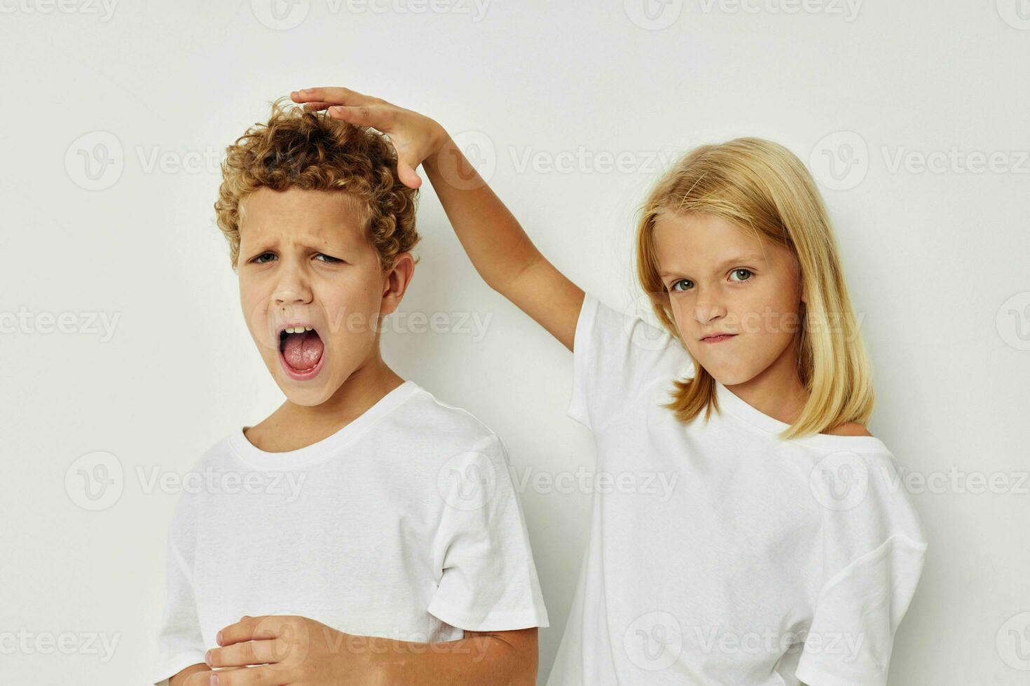 retrato do fofa crianças dentro branco Camisetas estão em pé Próximo para infância inalterado foto