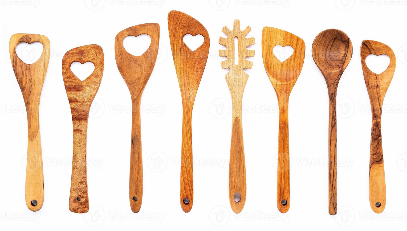 várias formas de coração de utensílios de cozinha de madeira, colheres de madeira e espátula de madeira isoladas em fundo branco foto