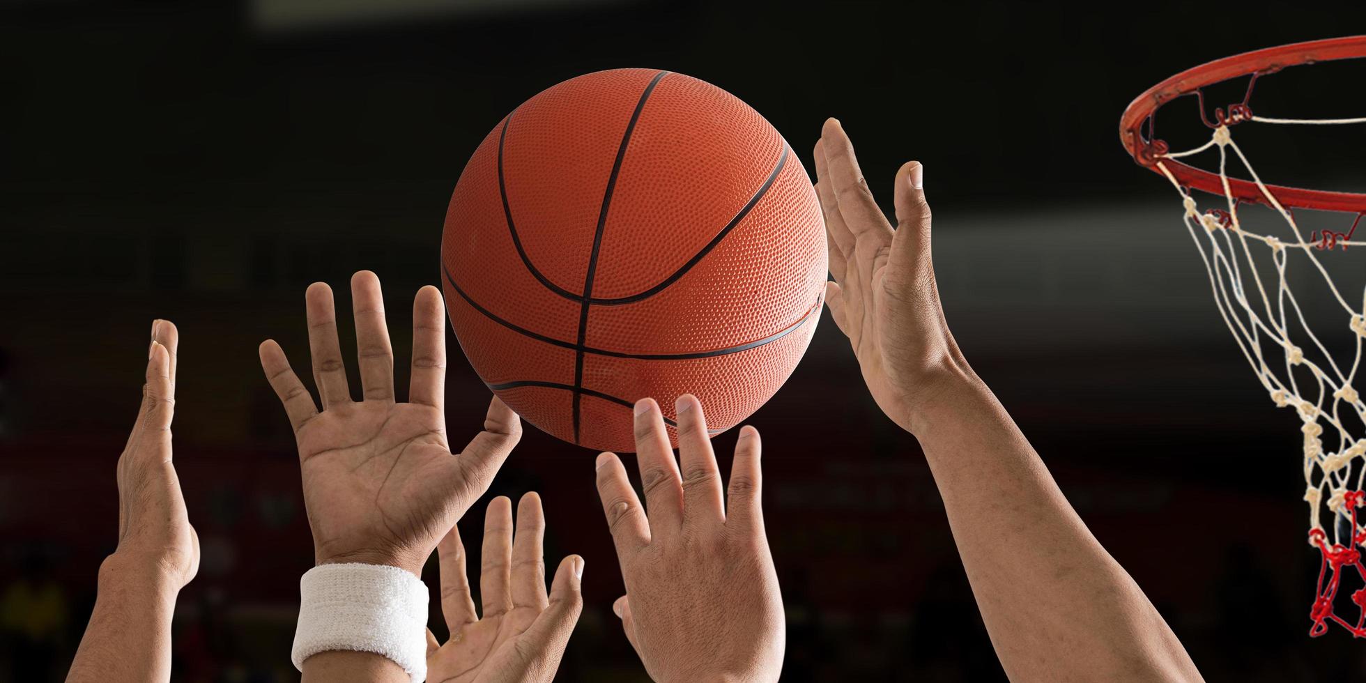 bola de basquete voando com uma cesta de basquete sobre uma quadra de basquete foto