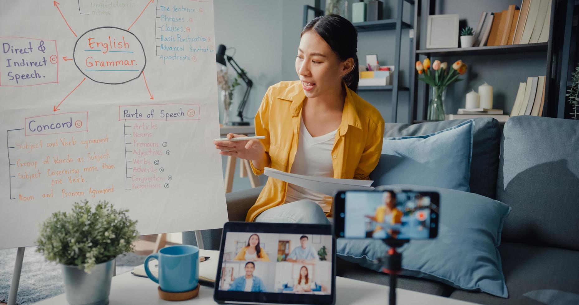 jovem asiática professora de inglês videoconferência ligando no smartphone conversa por webcam aprender ensinar no bate-papo online em casa foto