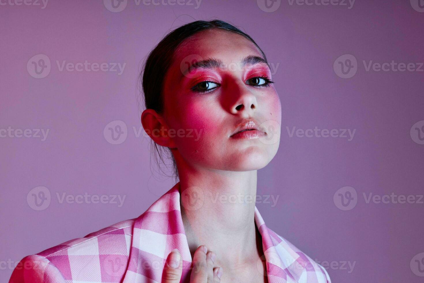 jovem lindo mulher xadrez blazer moda posando luxo Rosa fundo inalterado foto