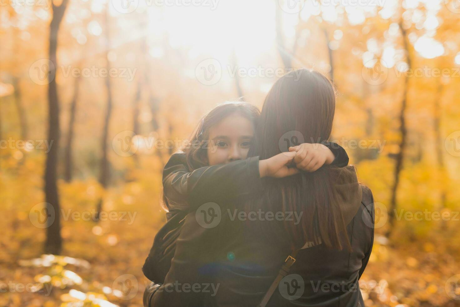 mãe e filha gastar Tempo juntos dentro outono amarelo parque. estação e solteiro pai conceito. foto