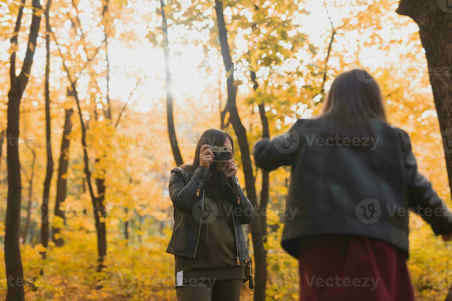 mãe fotógrafo leva As fotos do uma dela filha dentro a parque dentro outono. hobbies, foto arte e lazer conceito.