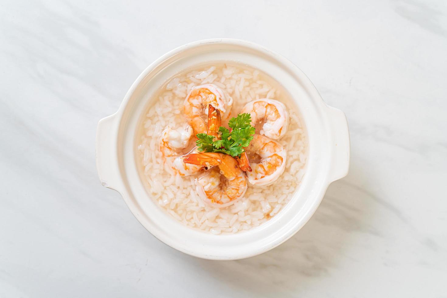 mingau ou sopa de arroz cozido com tigela de camarão foto