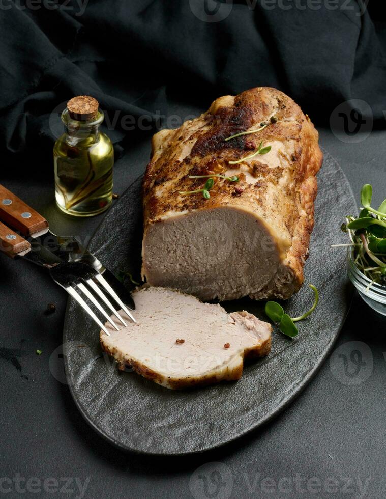 cozido peça do carne de porco balyk em a mesa com especiarias. filé mignon cortar para dentro peças foto