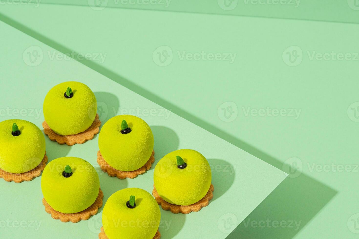 uma prato do sortido verde rosquinha guloseimas senta no topo uma de madeira mesa foto