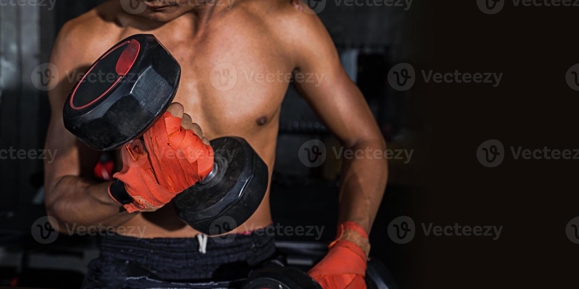 close up de um homem bonito poder esporte atlético com halteres, poderoso homem musculoso levantando peso, boxe tailandês foto