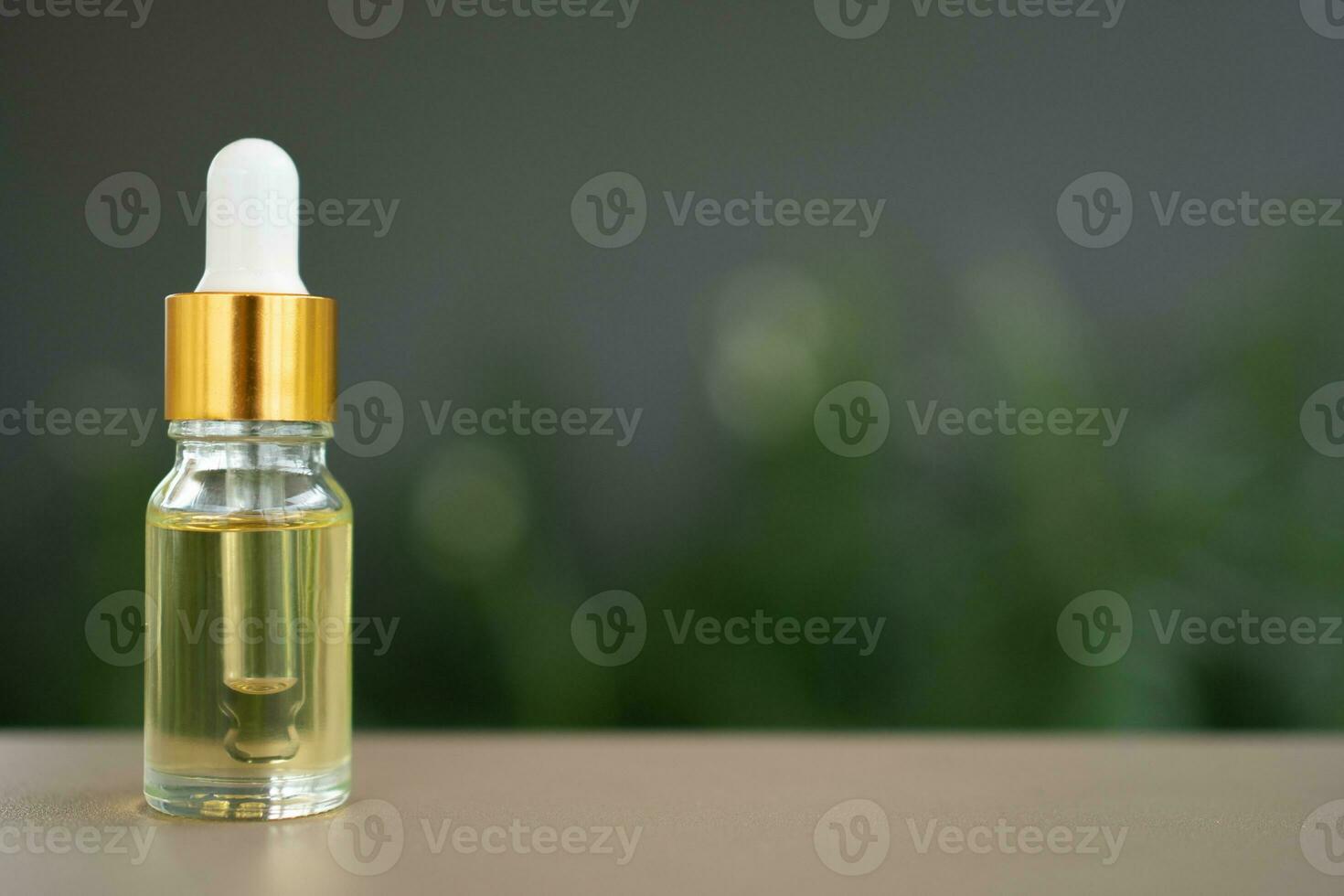 um frasco de vidro com conta-gotas em cima da mesa. conceito de óleo de aroma, cosméticos e pele de beleza. foto