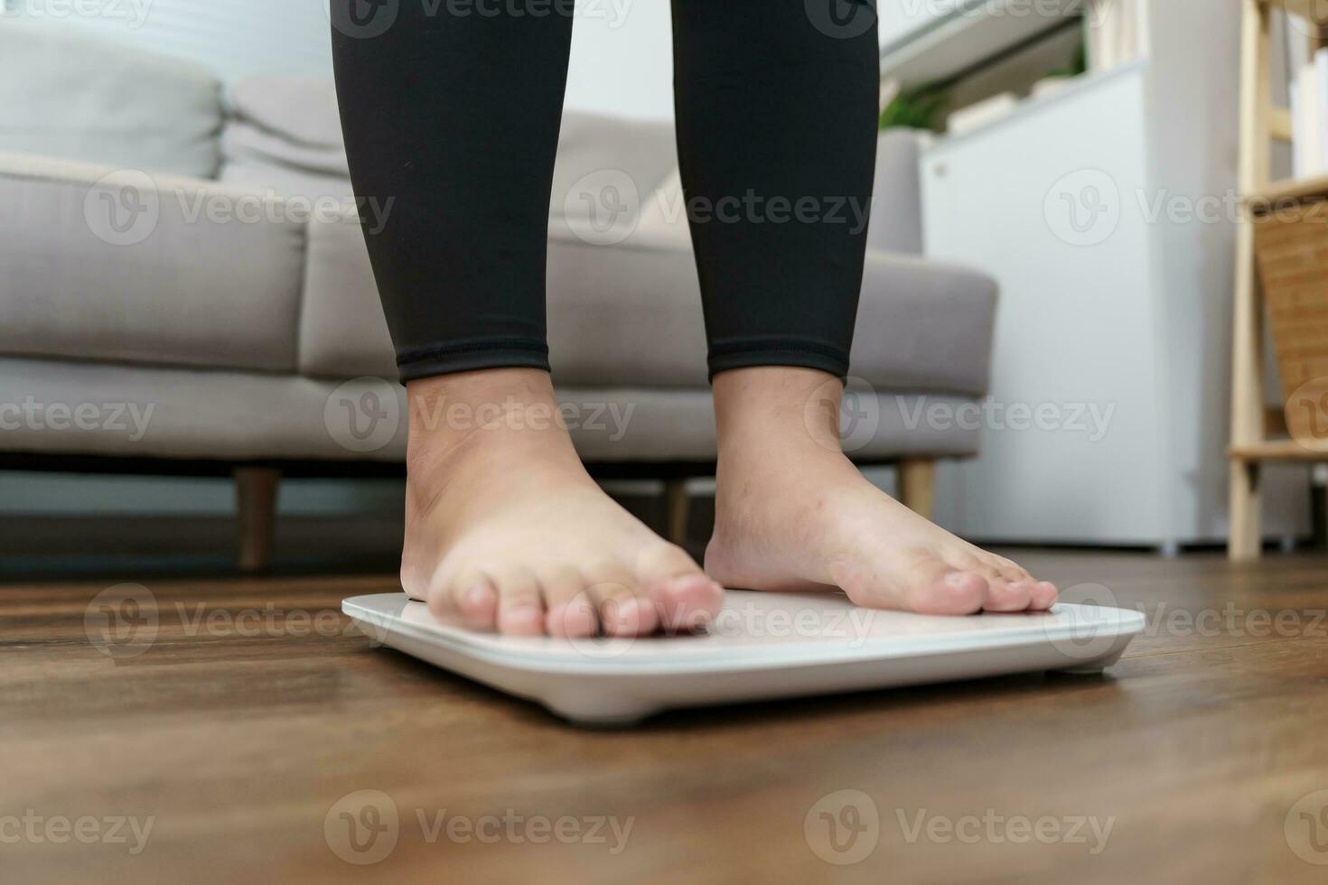 gordo dieta e escala pés em pé em eletrônico balanças para peso ao controle. medição instrumento dentro quilograma para uma dieta ao controle. foto