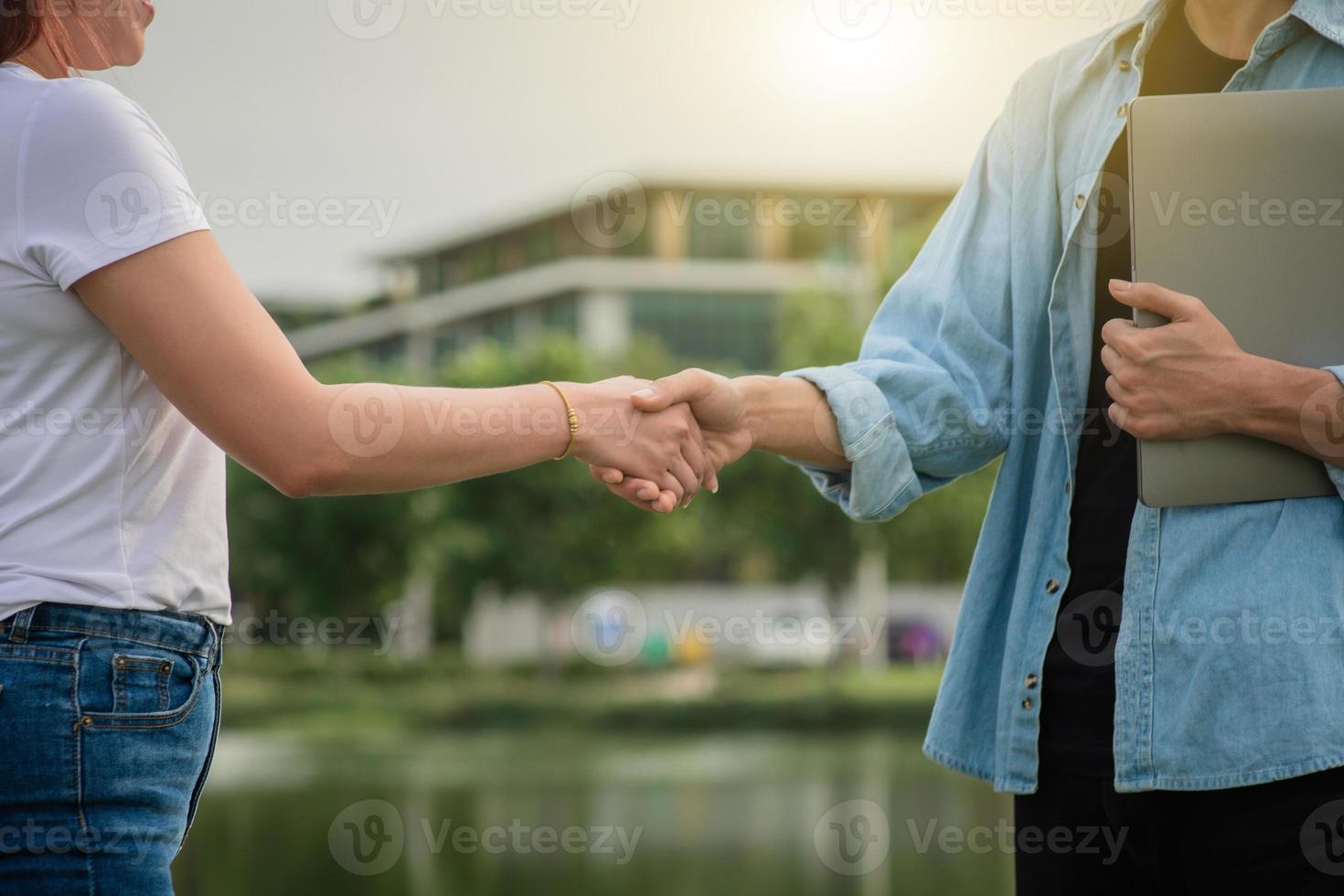 duas pessoas apertam a mão amizade ao ar livre, conceito aperto de mão foto