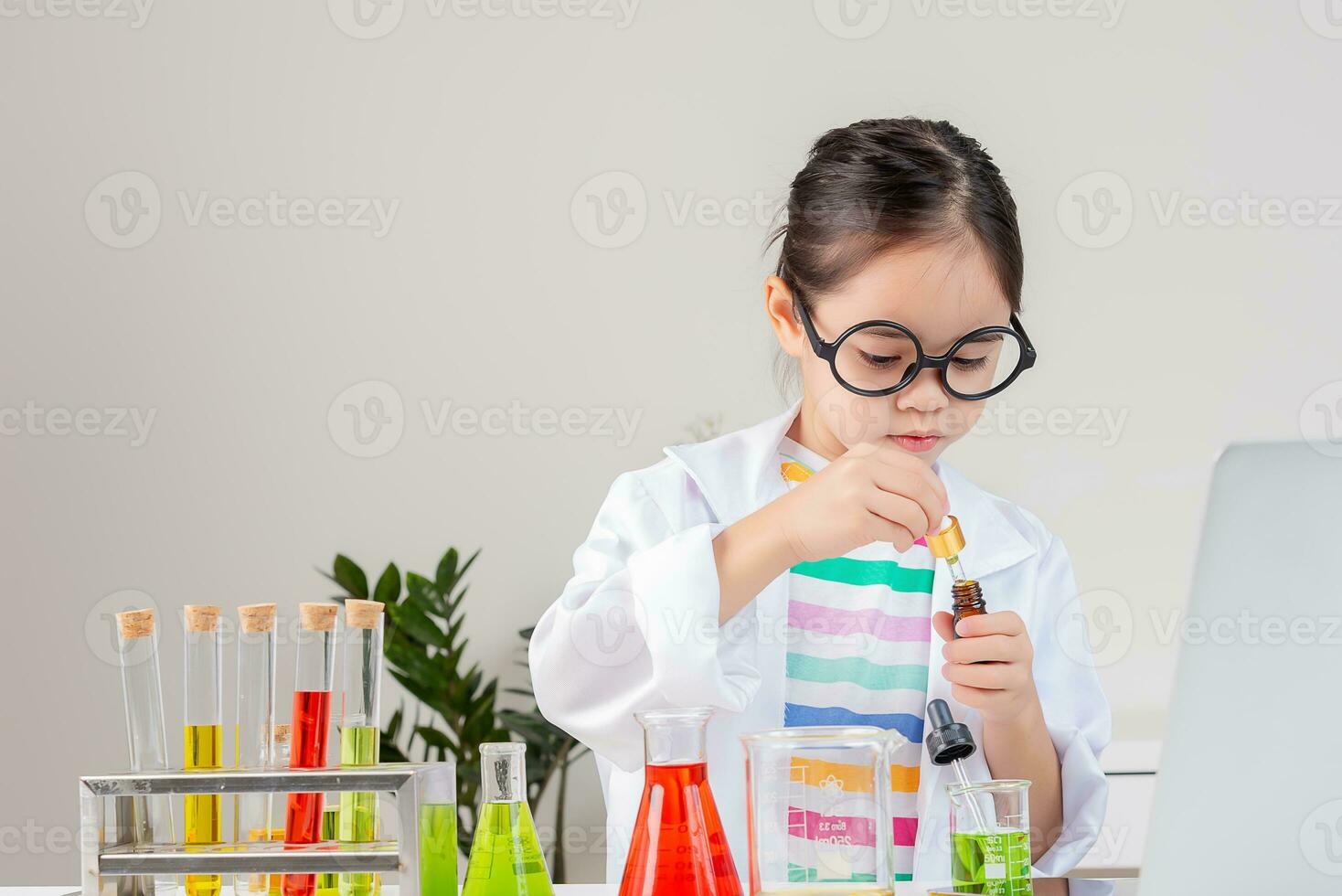 ásia pequeno menina trabalhando com teste tubo Ciência experimentar dentro branco Sala de aula foto