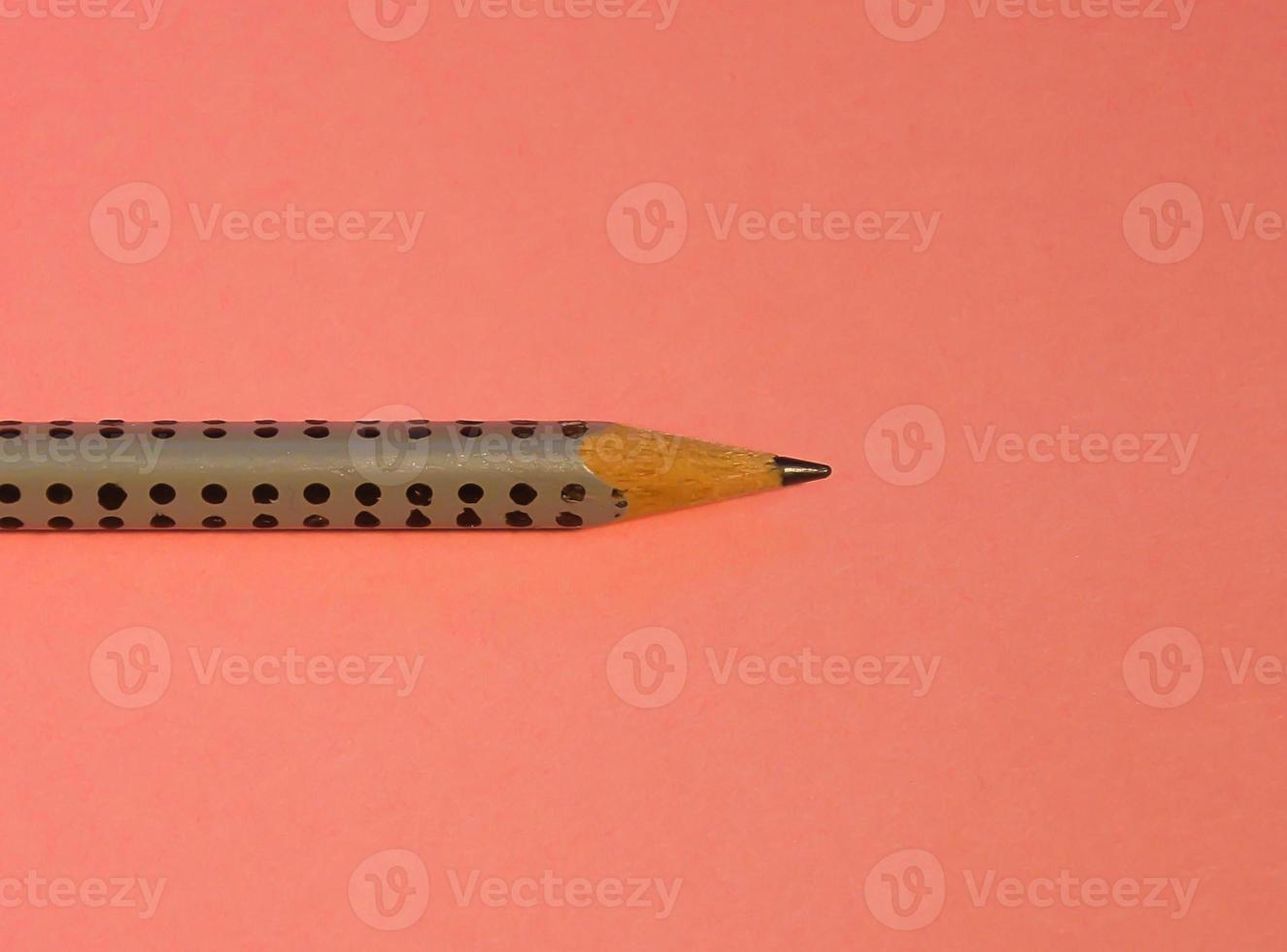 um lápis simples em um fundo rosa foto