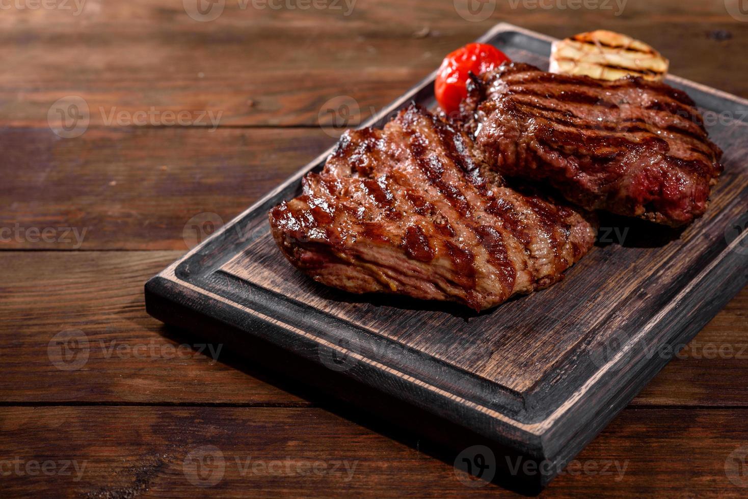 Bife fresco suculento delicioso em um fundo escuro foto