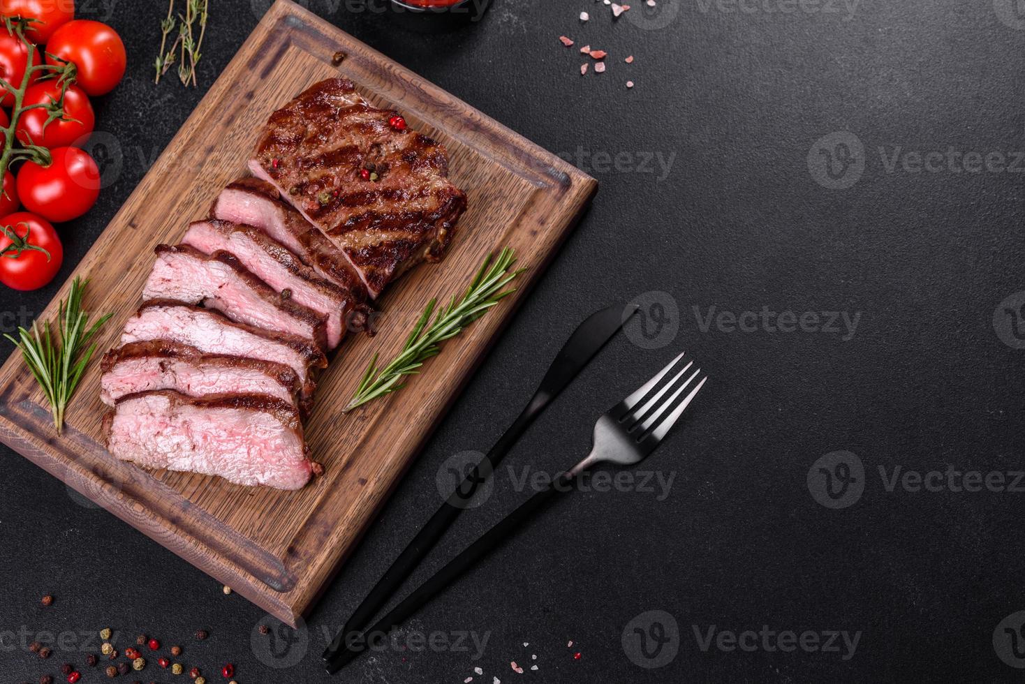 Bife fresco suculento delicioso em um fundo escuro foto