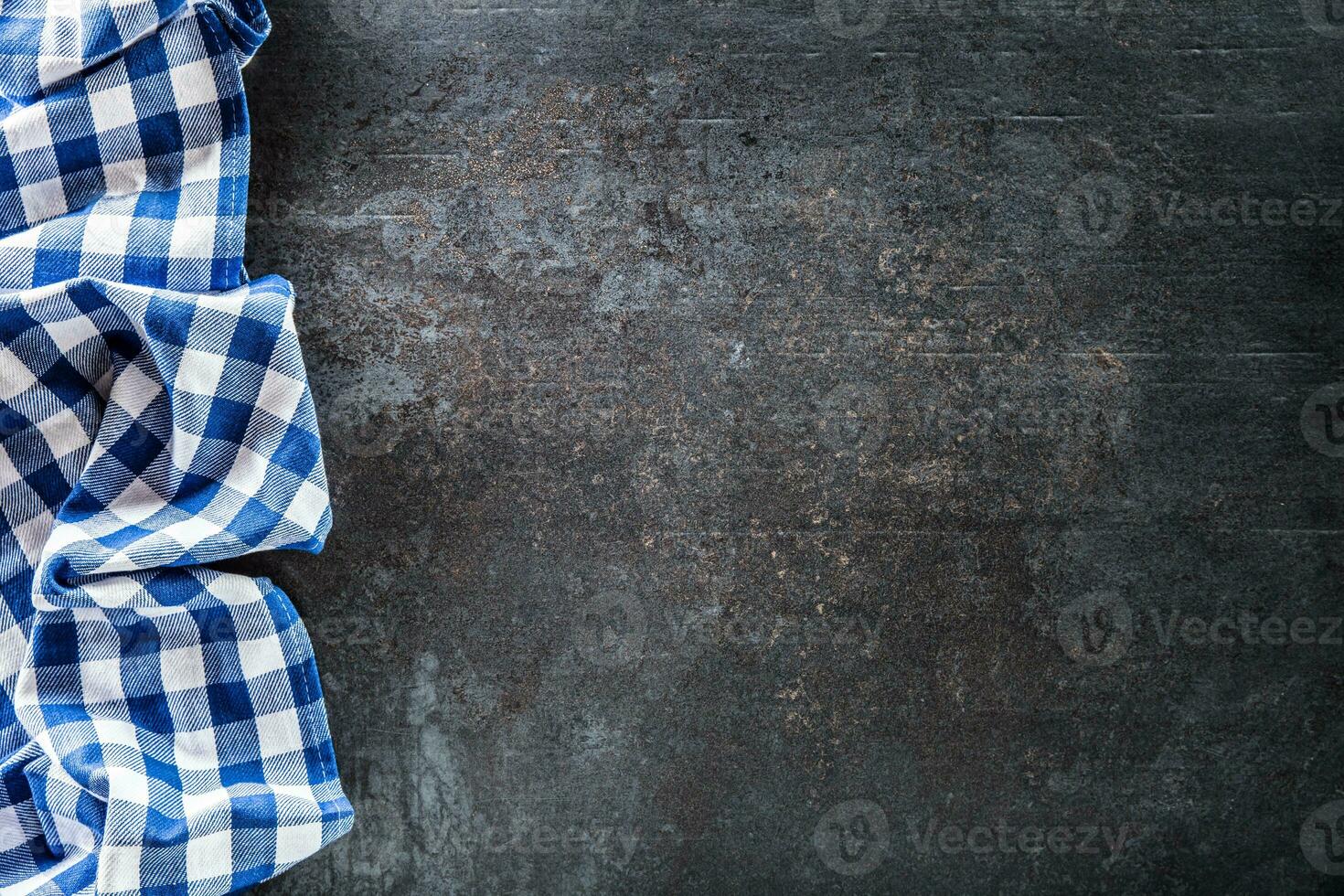 topo do Visão azul xadrez toalha de mesa em Sombrio concreto mesa. foto
