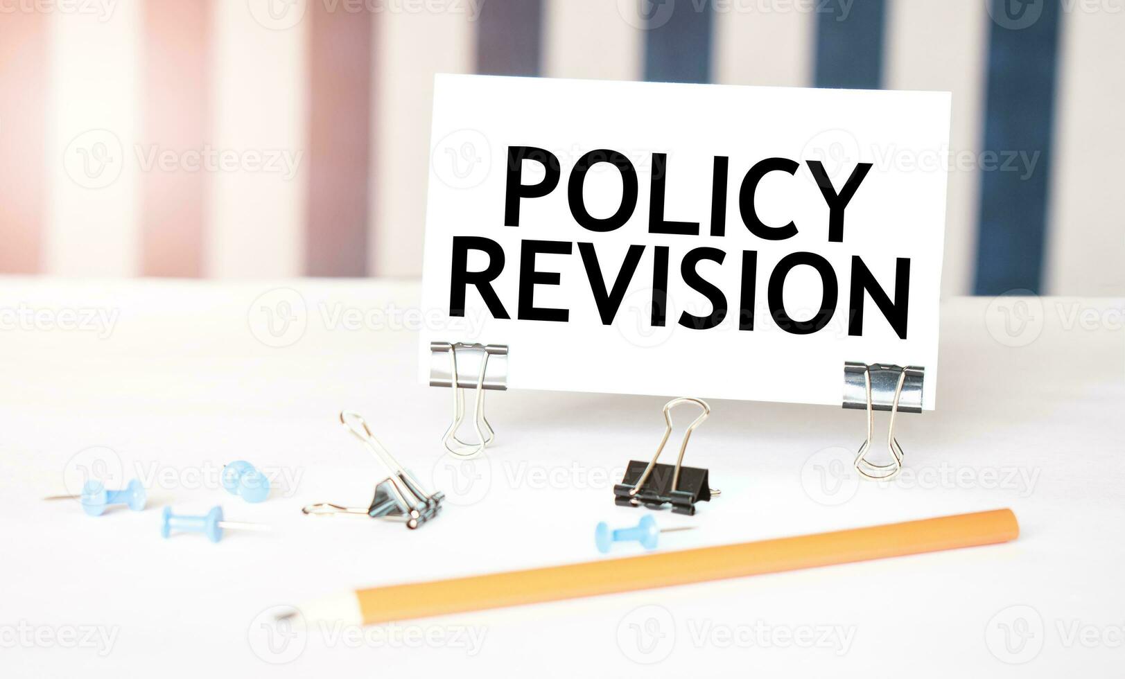 política revisão placa em papel em branco escrivaninha com escritório ferramentas. azul e branco fundo foto