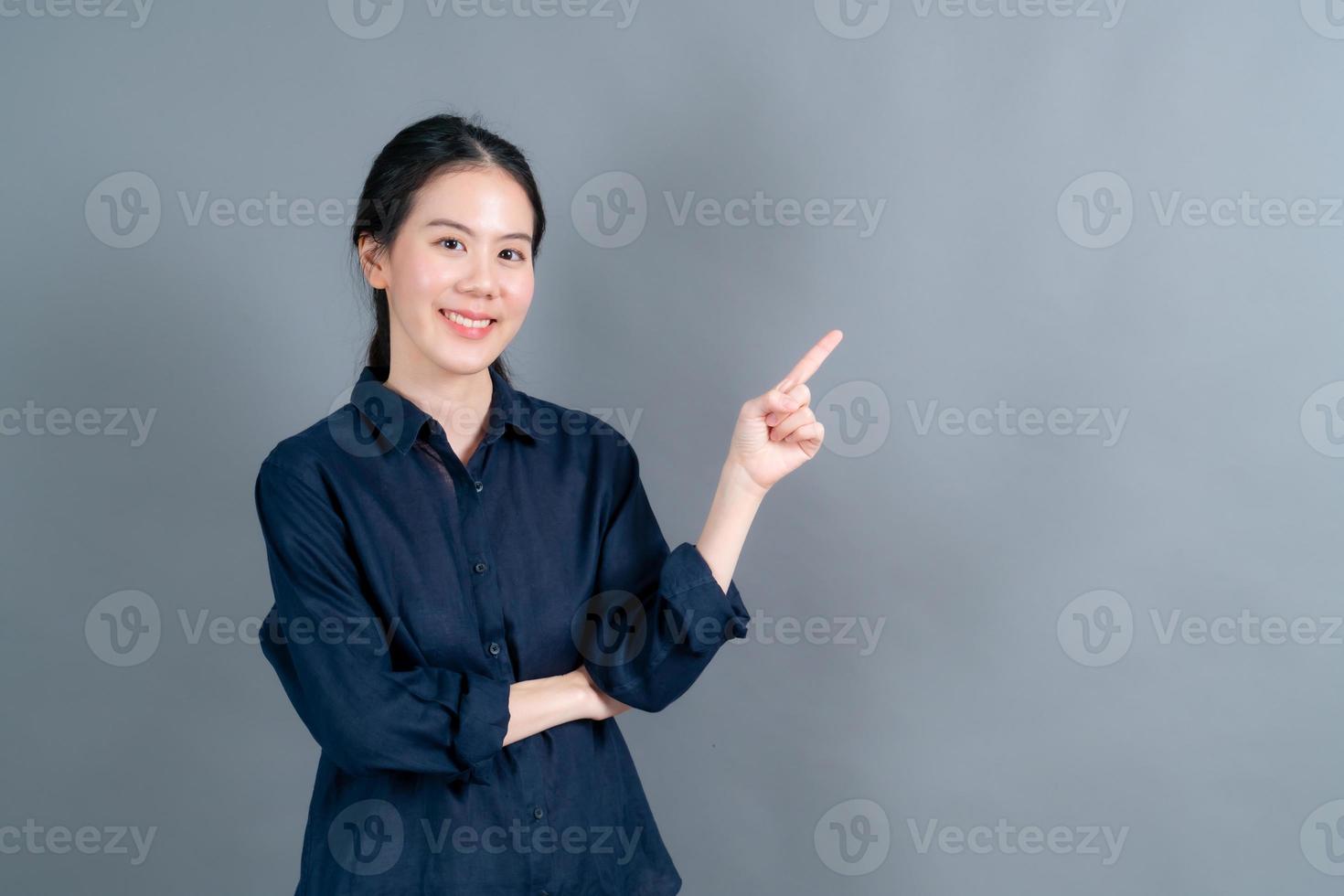 mulher asiática com mão apresentando-se de lado foto