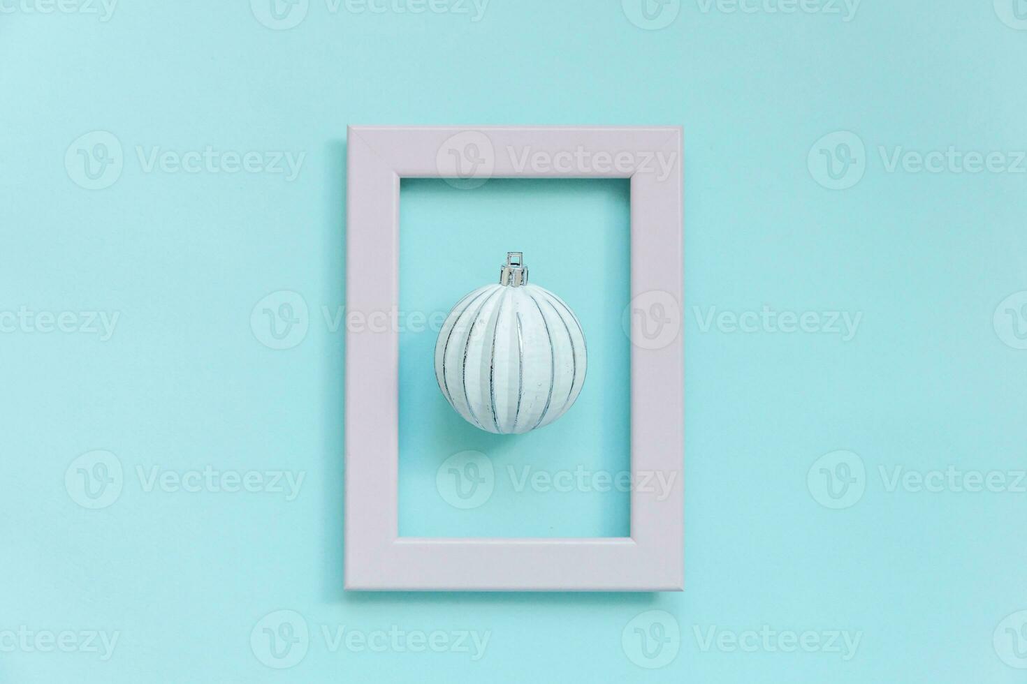 simplesmente mínimo composição inverno objetos enfeite bola dentro Rosa quadro, Armação isolado em azul pastel na moda fundo foto