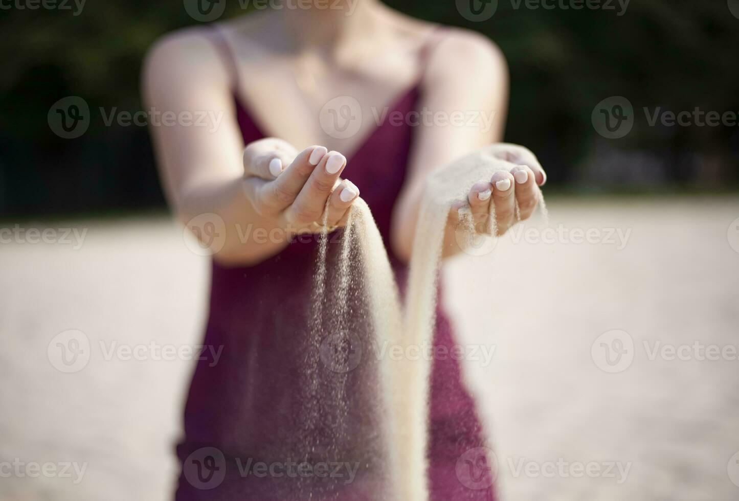 jovem mulher com areia dentro mãos foto