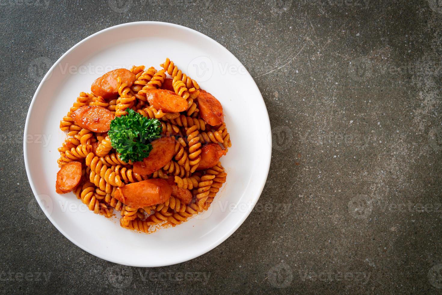 macarrão espiral ou espiral com molho de tomate e salsicha - comida italiana foto