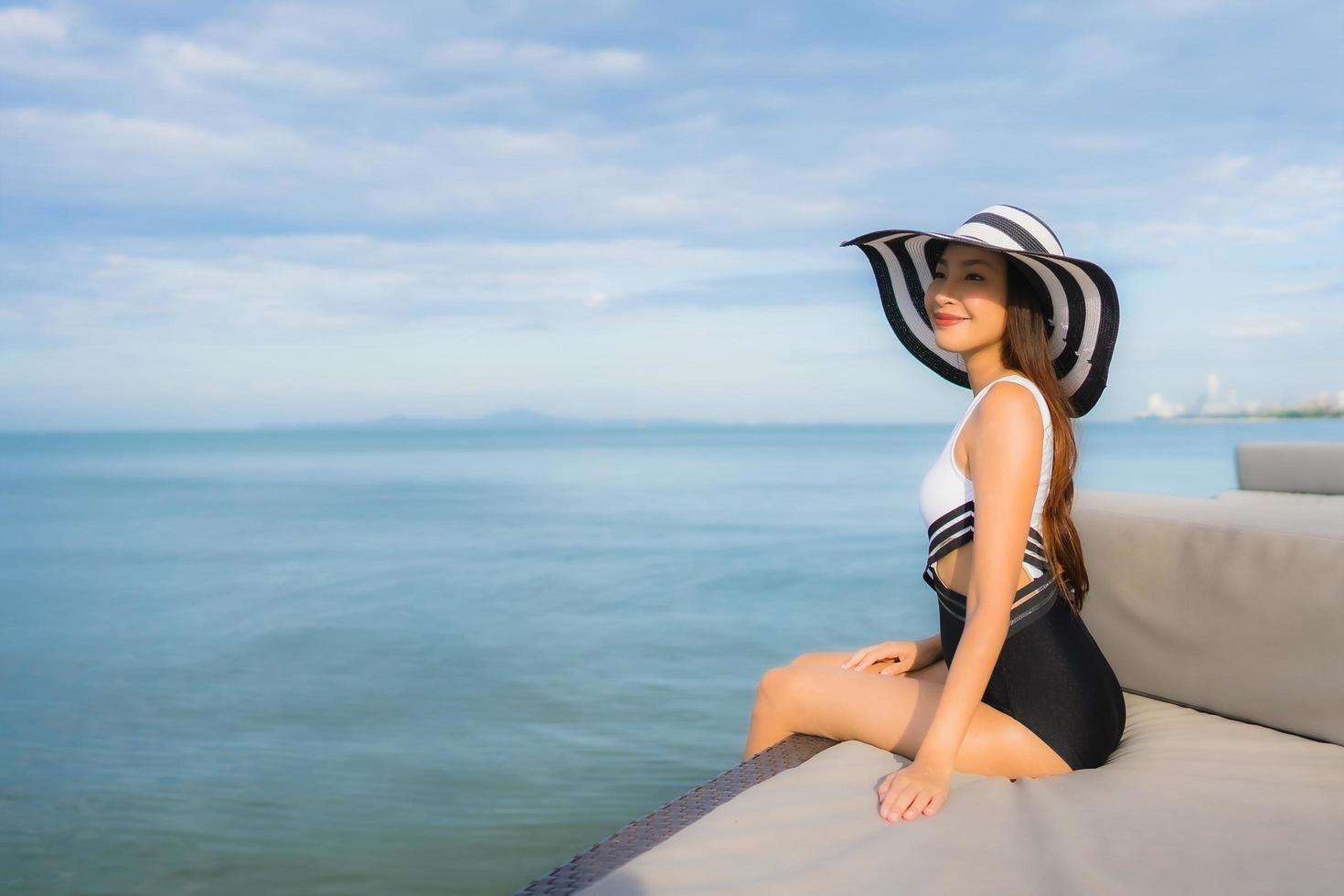 retrato lindas jovens mulheres asiáticas relaxando sorriso feliz em torno do mar, praia, oceano foto