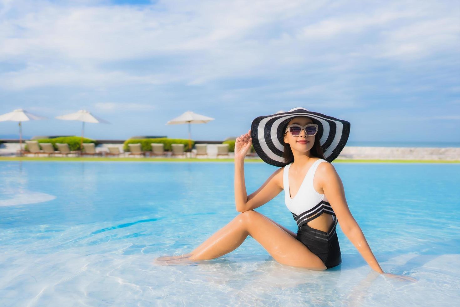 retrato lindas jovens mulheres asiáticas sorrindo feliz relaxando na piscina foto