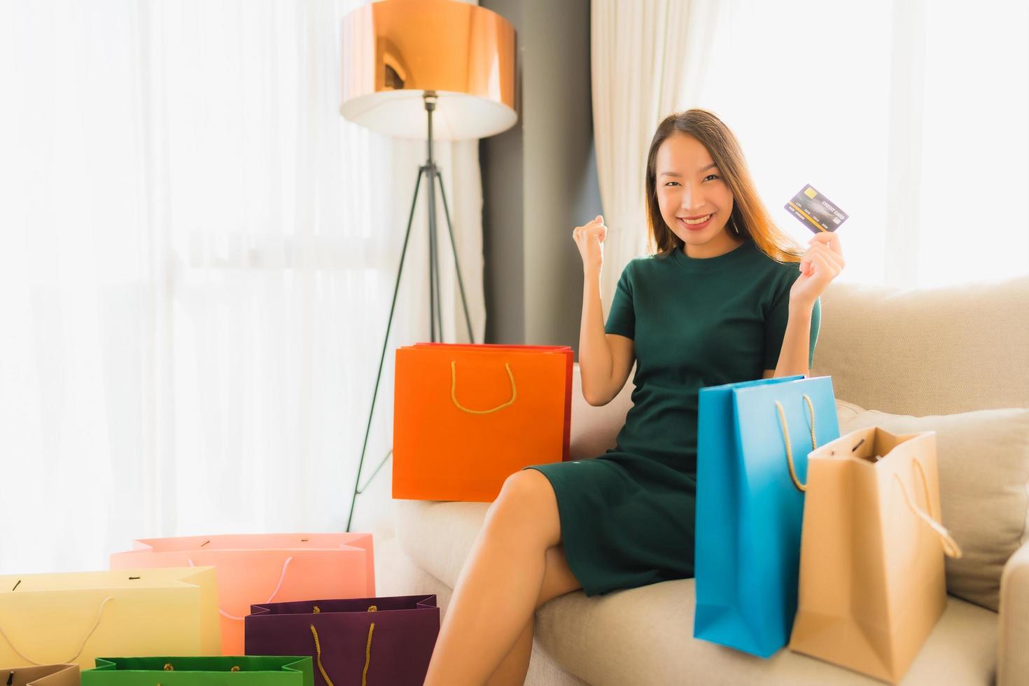 retrato de belas jovens mulheres asiáticas usando computador, laptop ou smartphone e celular com cartão de crédito para fazer compras online foto