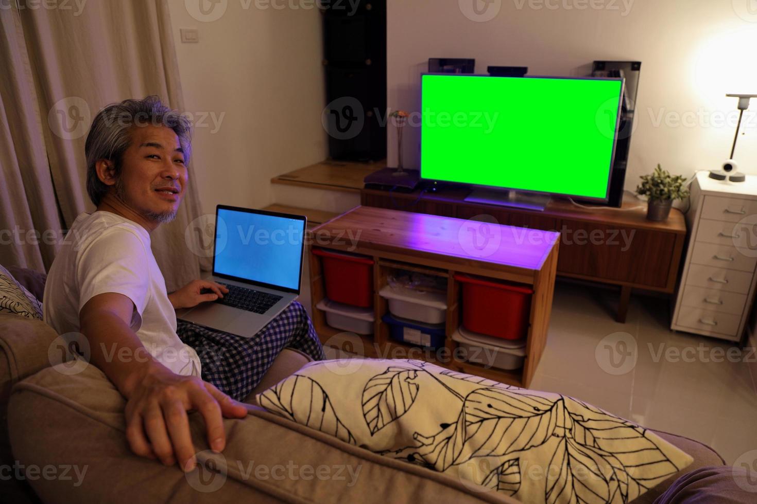 homem asiático assistindo televisão foto