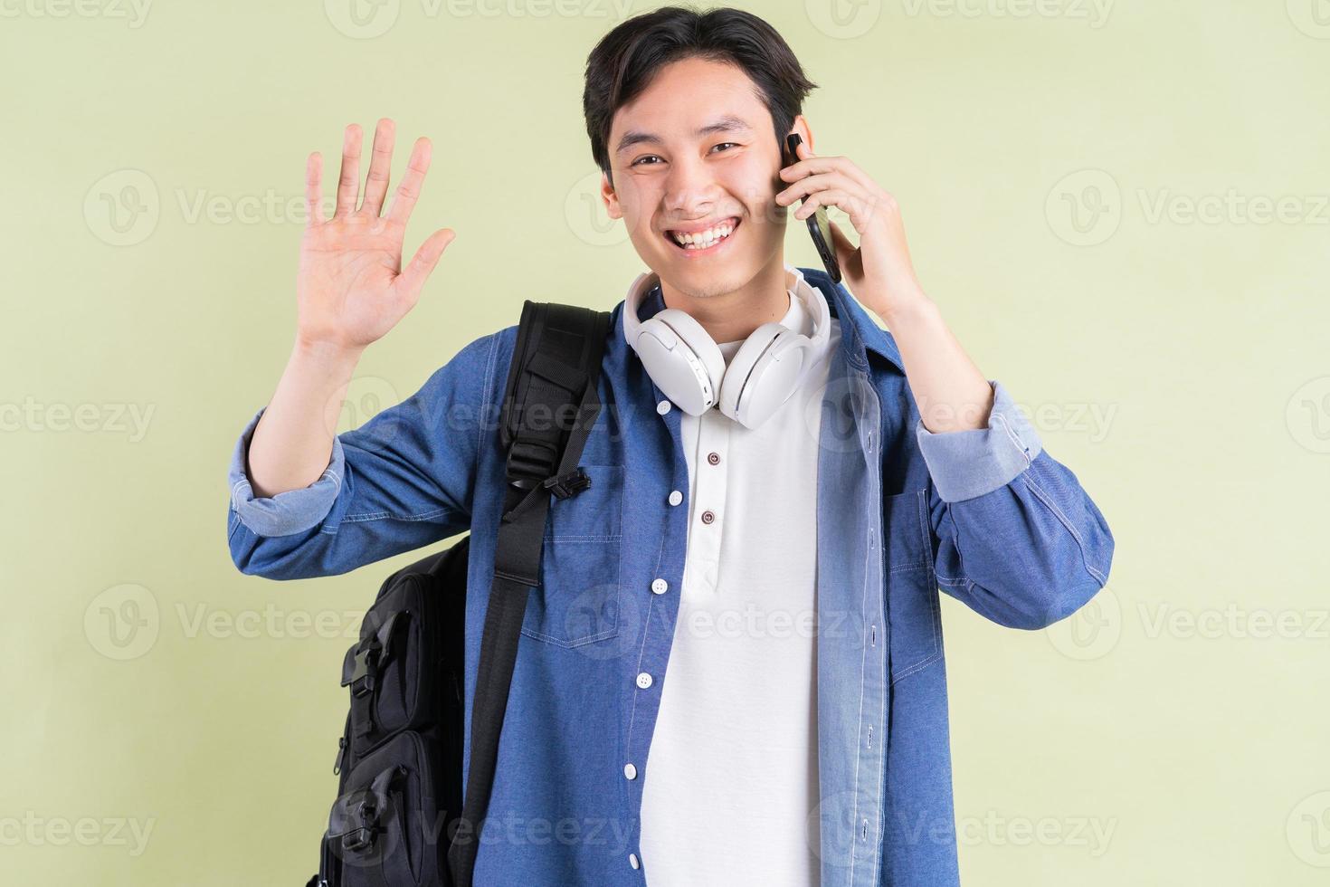 retrato do bonito estudante asiático ao telefone foto