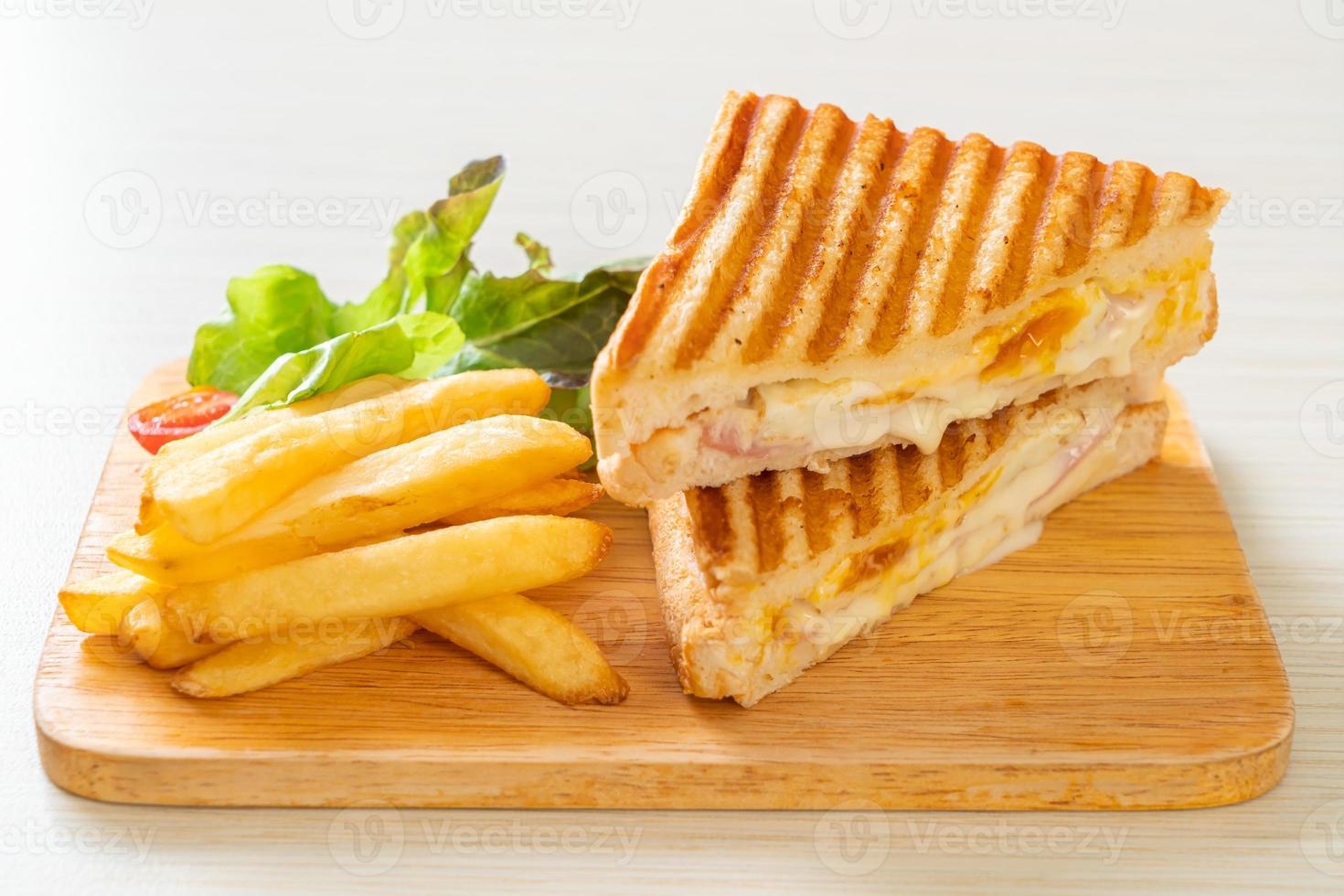 sanduíche de presunto e queijo com ovo e batata frita foto