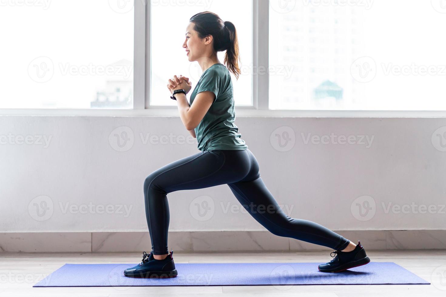 jovem fazendo exercícios em casa com uma expressão alegre foto