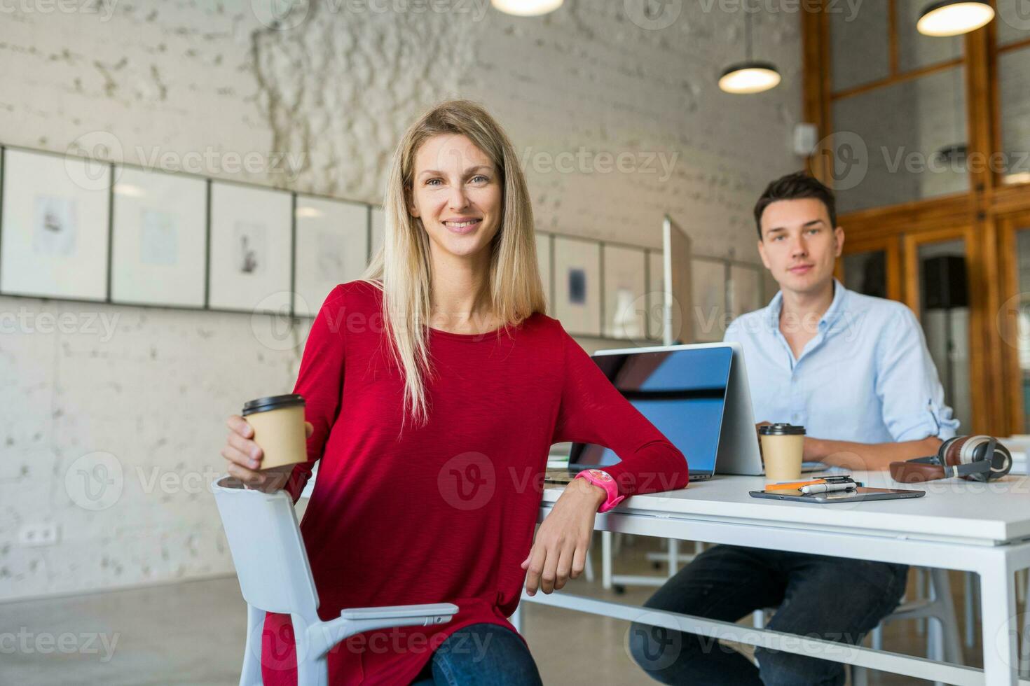 jovem homem e mulher trabalhando em computador portátil dentro aberto espaço co-trabalho escritório sala, ocupado freelancers foto