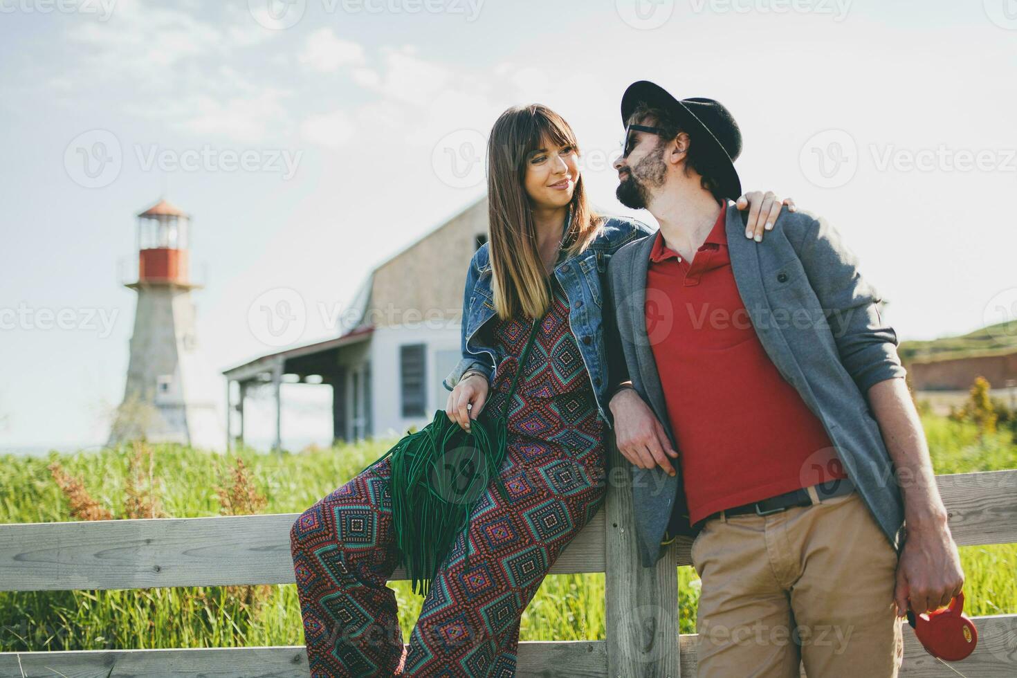 rindo jovem hipster casal indie estilo dentro amor caminhando dentro campo foto