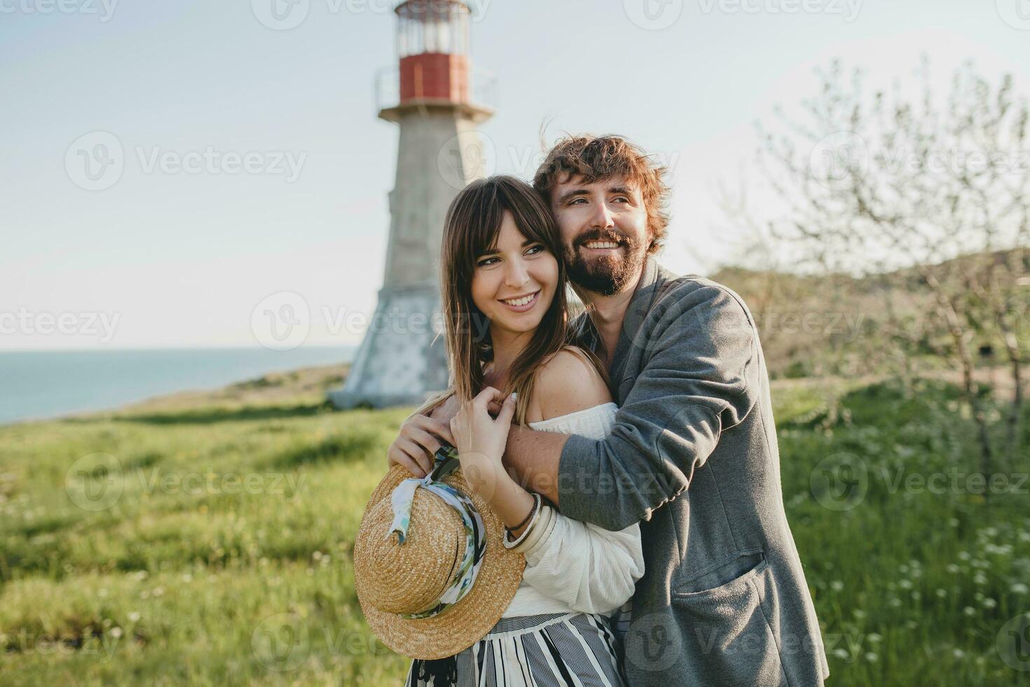 rindo jovem hipster casal indie estilo dentro amor caminhando dentro campo foto