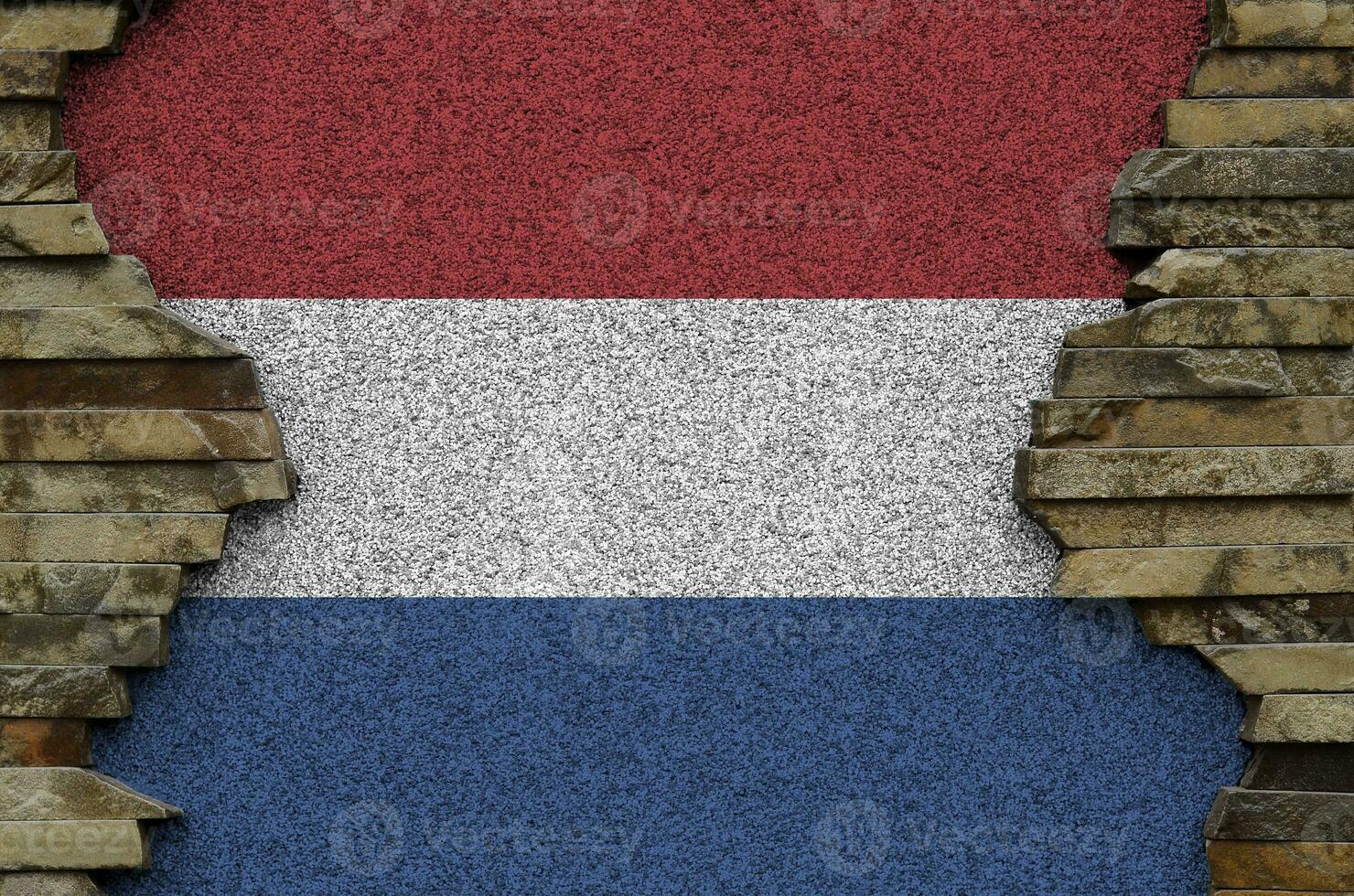 Países Baixos bandeira retratado dentro pintura cores em velho pedra parede fechar-se. texturizado bandeira em Rocha parede fundo foto