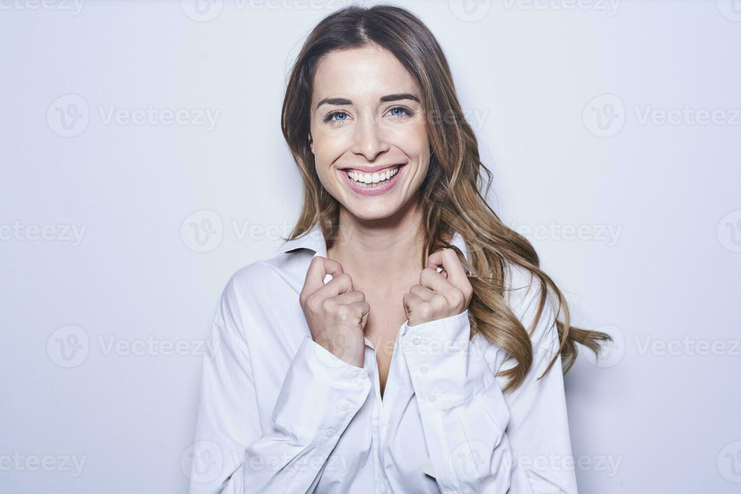 retrato do rindo jovem mulher vestindo branco blusa foto