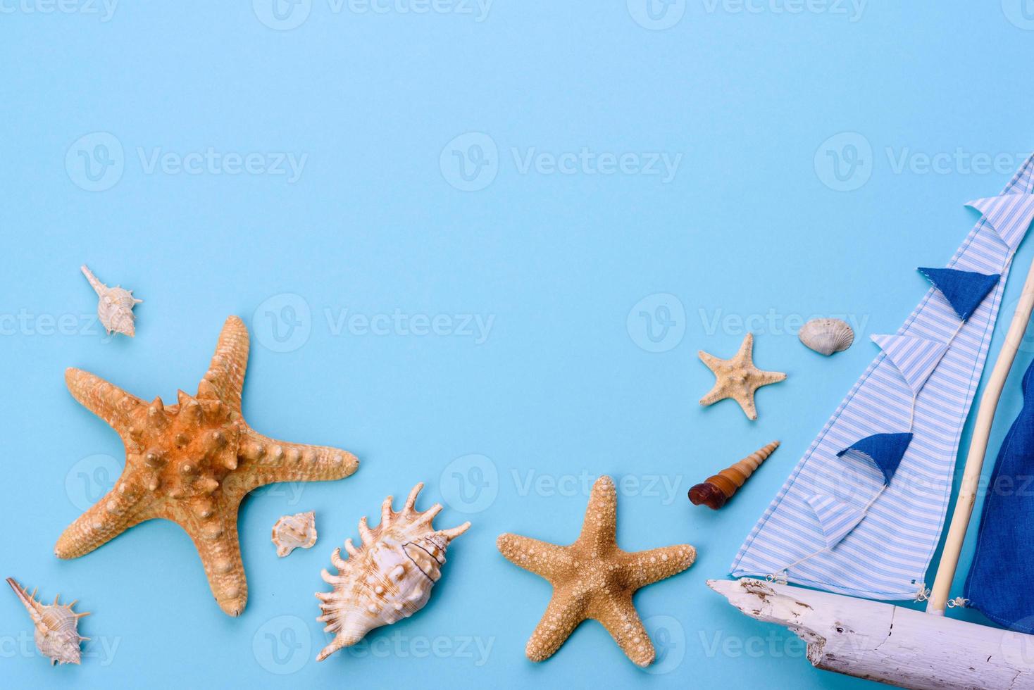 óculos e chapéu com conchas e estrelas do mar em um fundo colorido foto