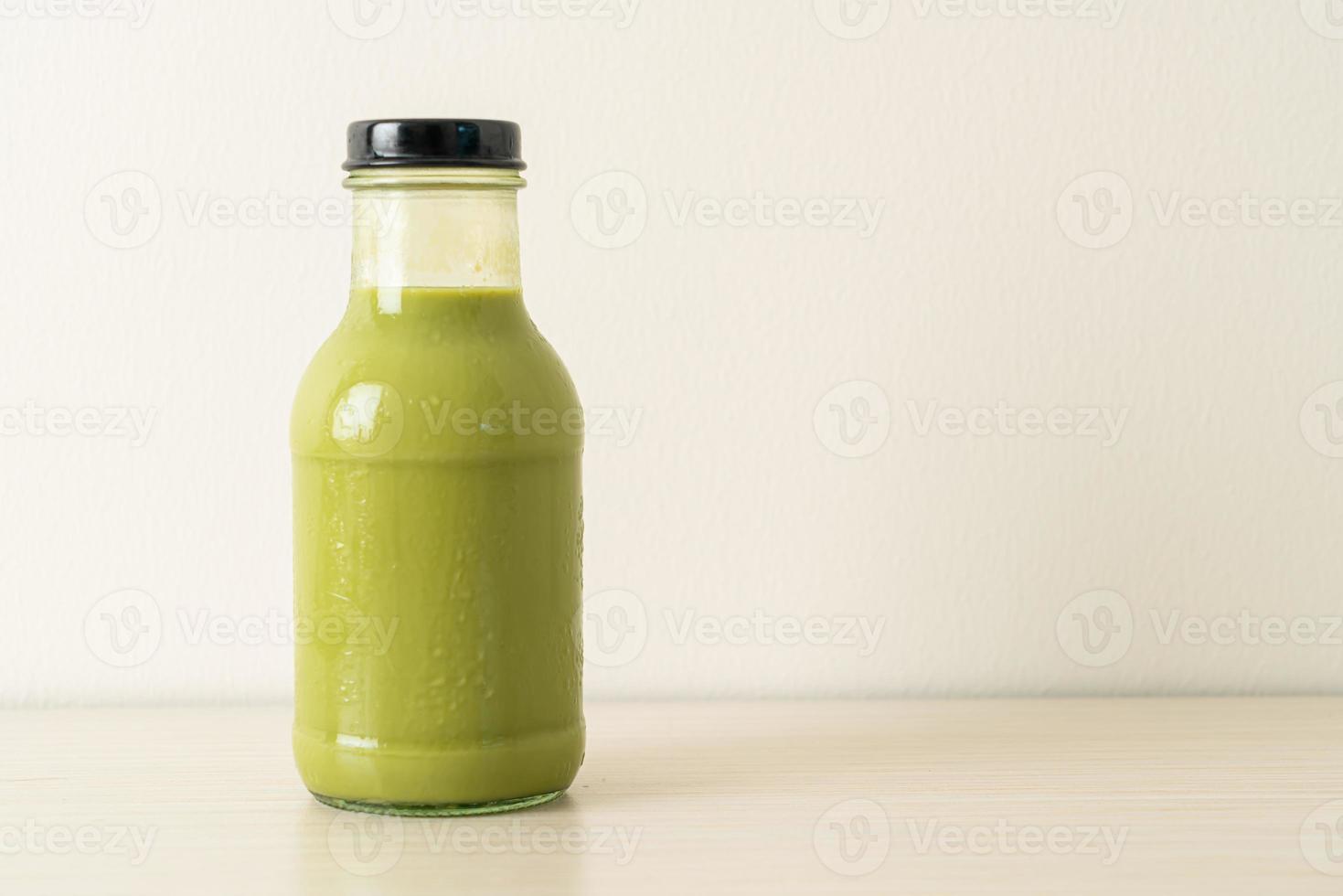 matcha chá verde com leite em garrafa de vidro na mesa foto