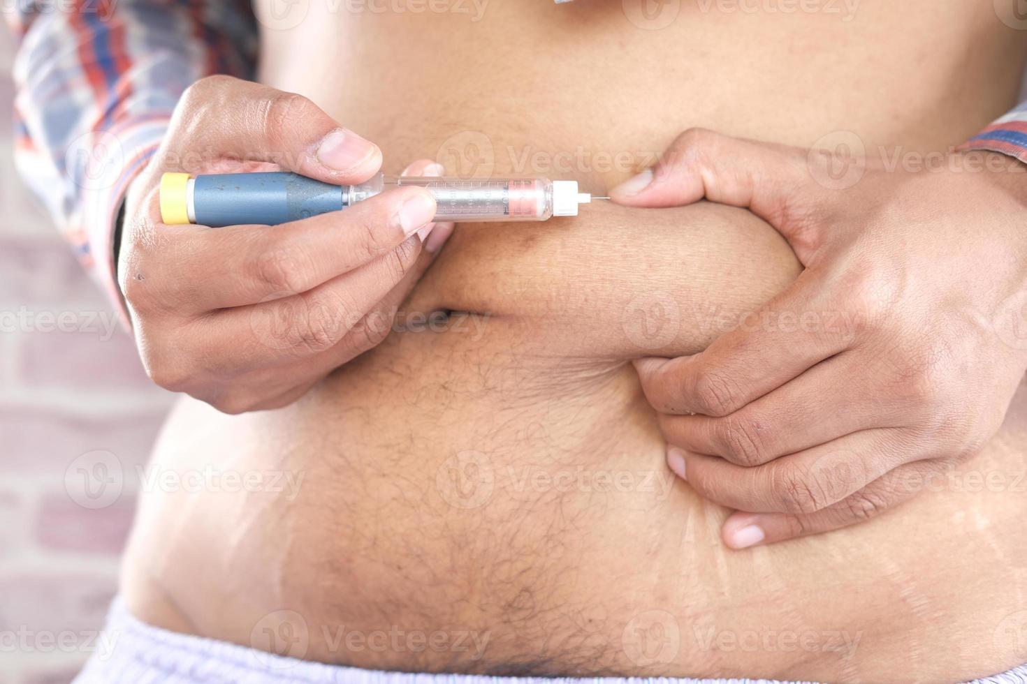 mão de jovem usando caneta de insulina close-up foto