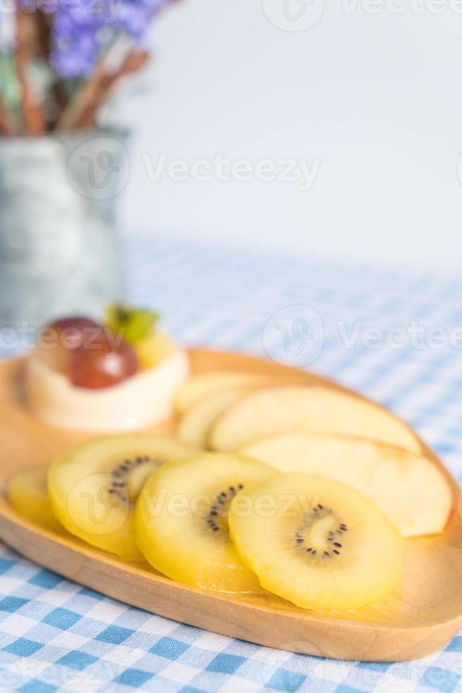 Pudim de frutas com kiwi e maçã na mesa foto