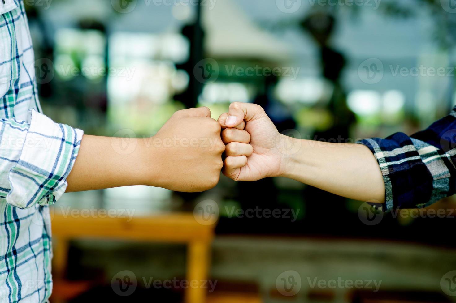 close-up da unidade de trabalho em equipe de dois punhos de duas mãos mostrando foto