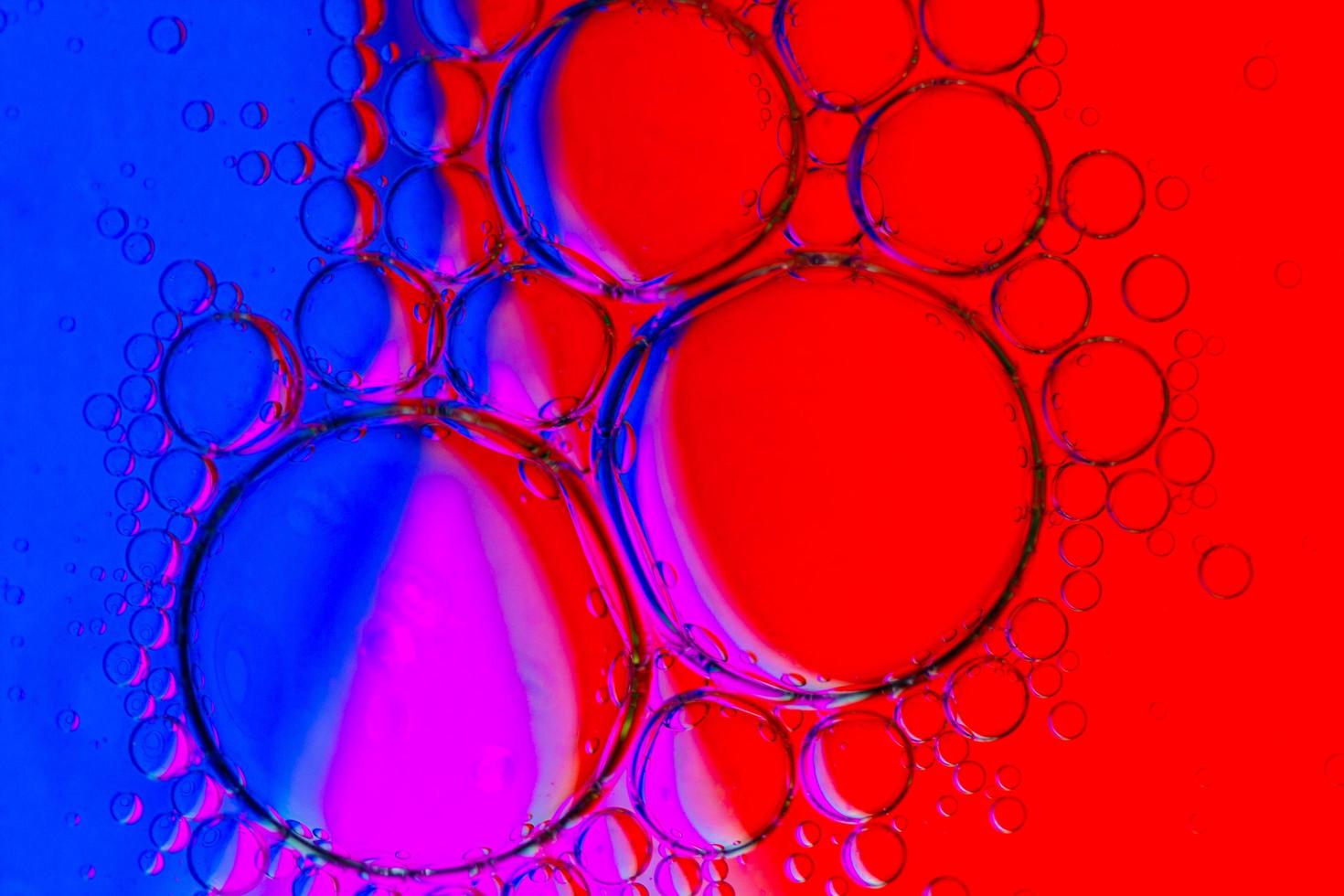 fundo abstrato de bolhas de óleo na superfície da água púrpura vermelho azul magenta paleta colorida foto