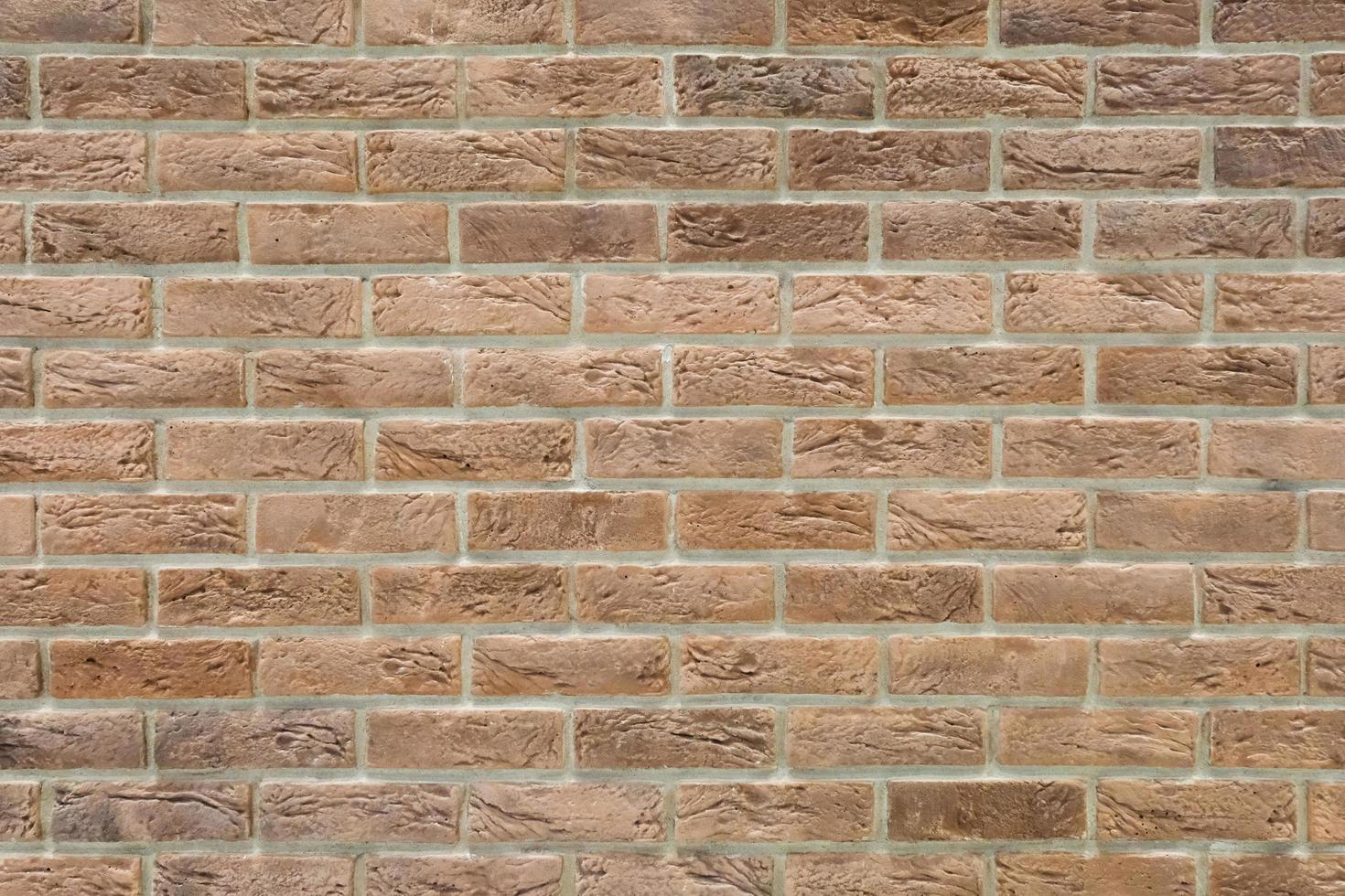 parede de tijolos decorativos marrom com textura envelhecida isolada closeup foto