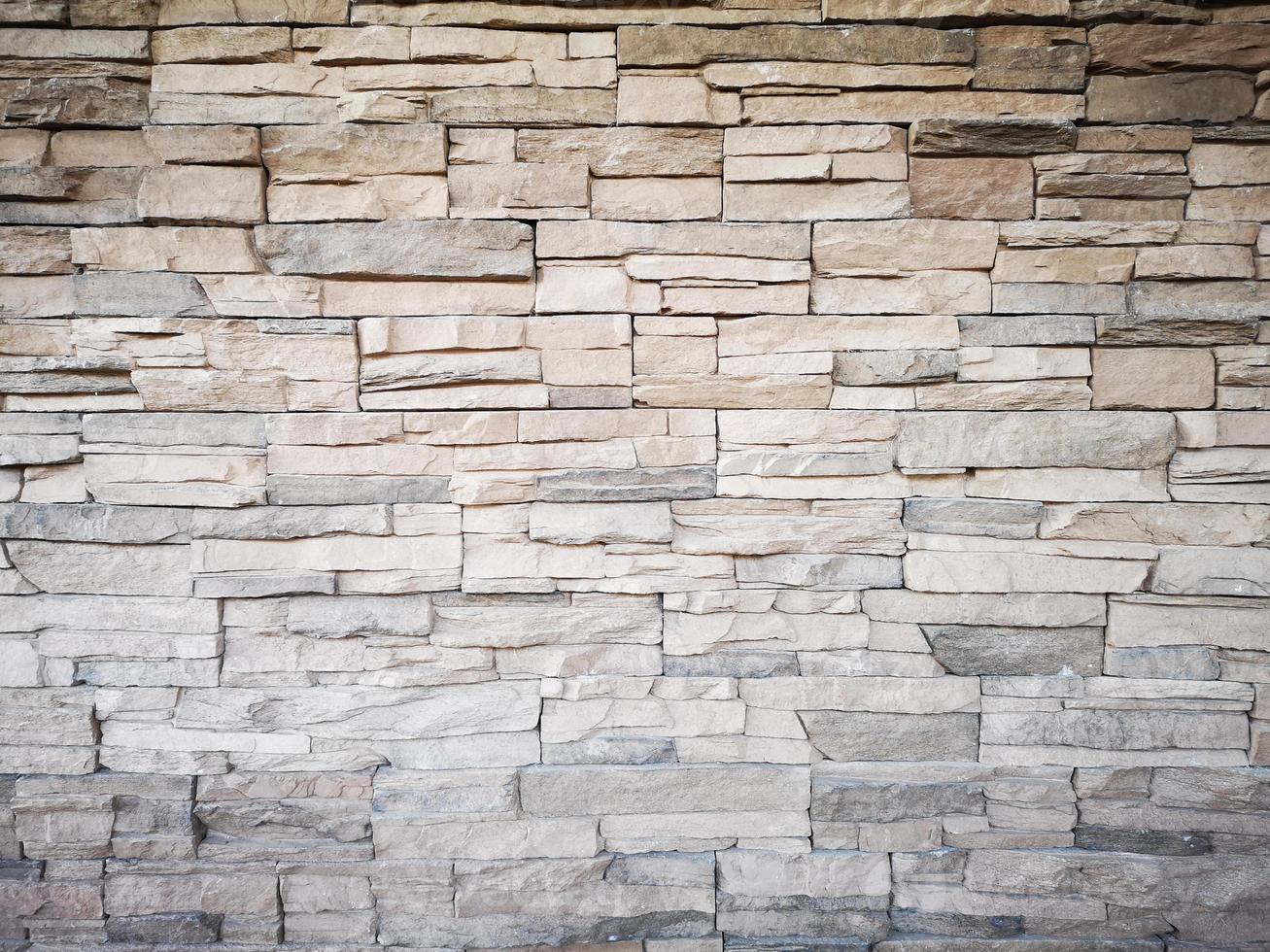 close-up de uma parede de tijolos de pedra cinza moderna usada como plano de fundo foto
