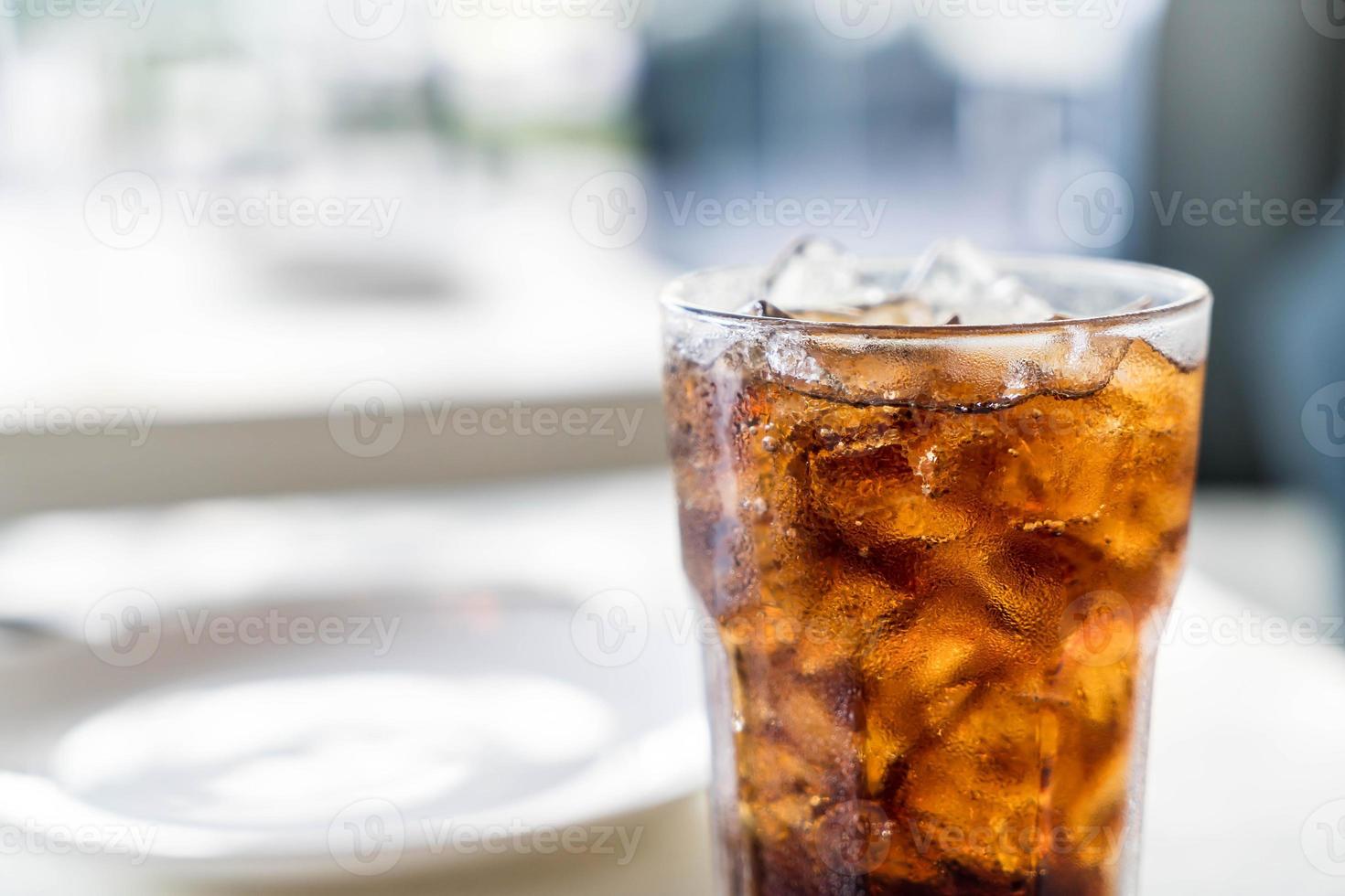 copo de cola gelado na mesa foto