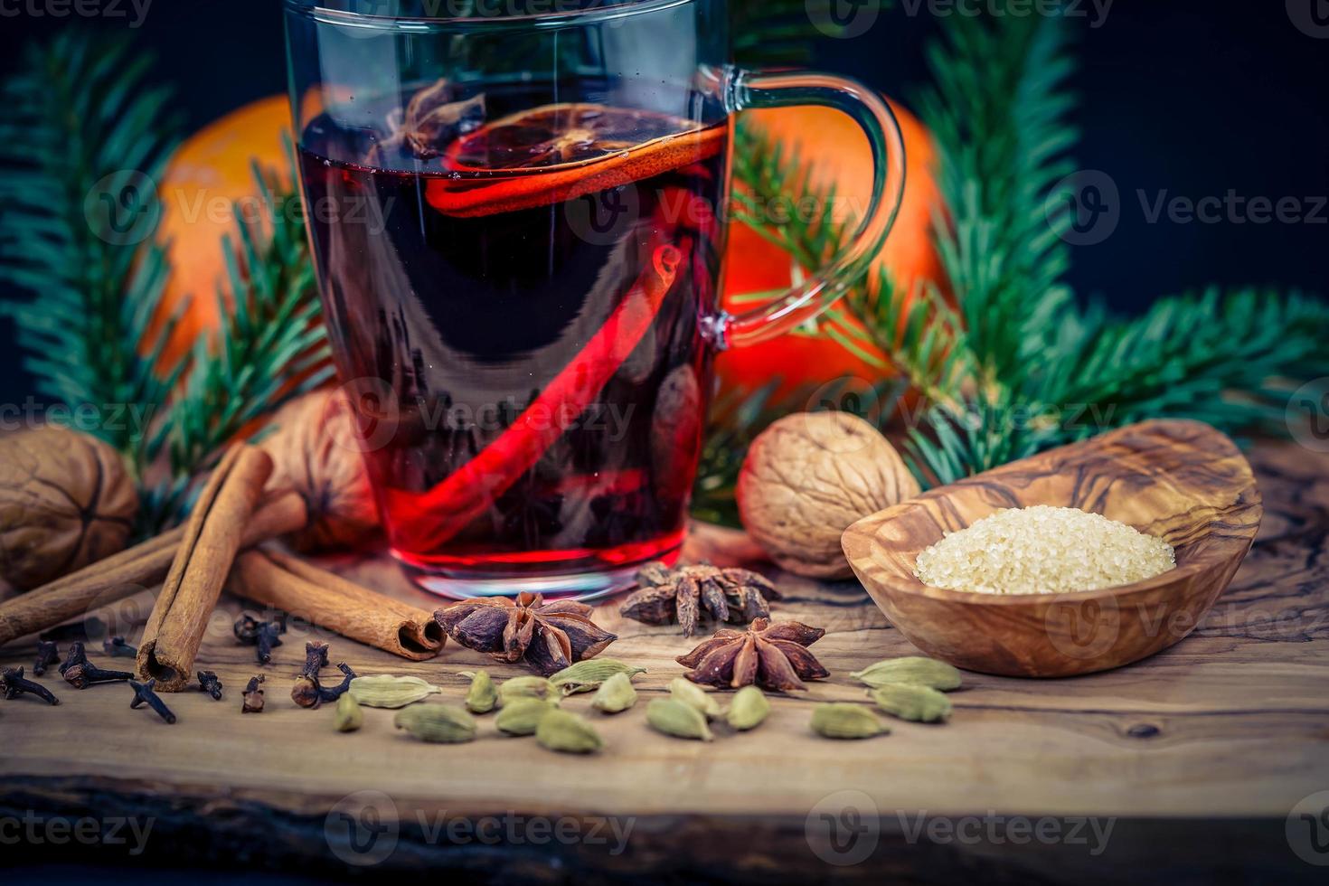 vinho quente e especiarias de natal em madeira de oliveira foto