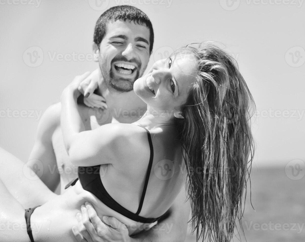 feliz casal jovem tem tempo romântico na praia foto