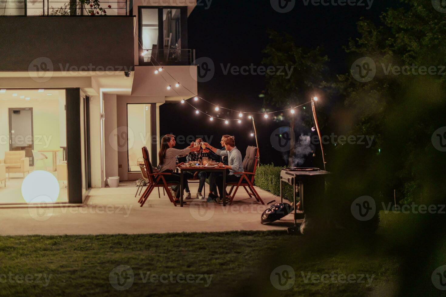 uma grupo do jovem diverso pessoas tendo jantar em a terraço do uma moderno casa dentro a tarde. Diversão para amigos e família. celebração do feriados, casamentos com churrasco. foto