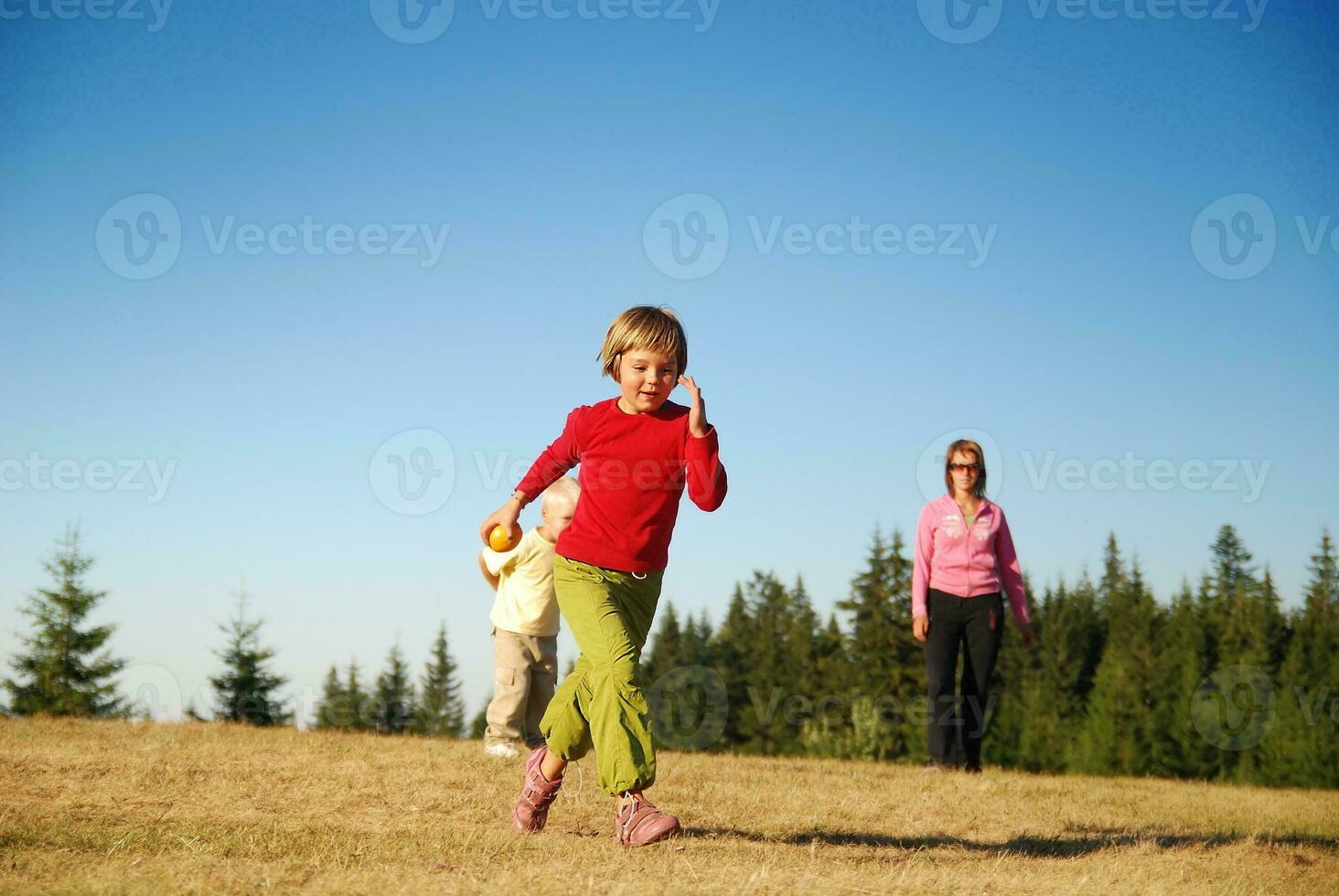 mãe e filhos se divertindo lá fora foto